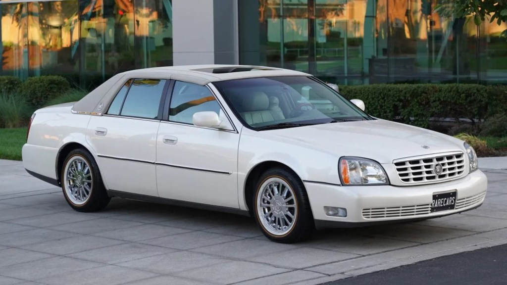 A white 2003 Cadillac DeVille parked in right front angle view