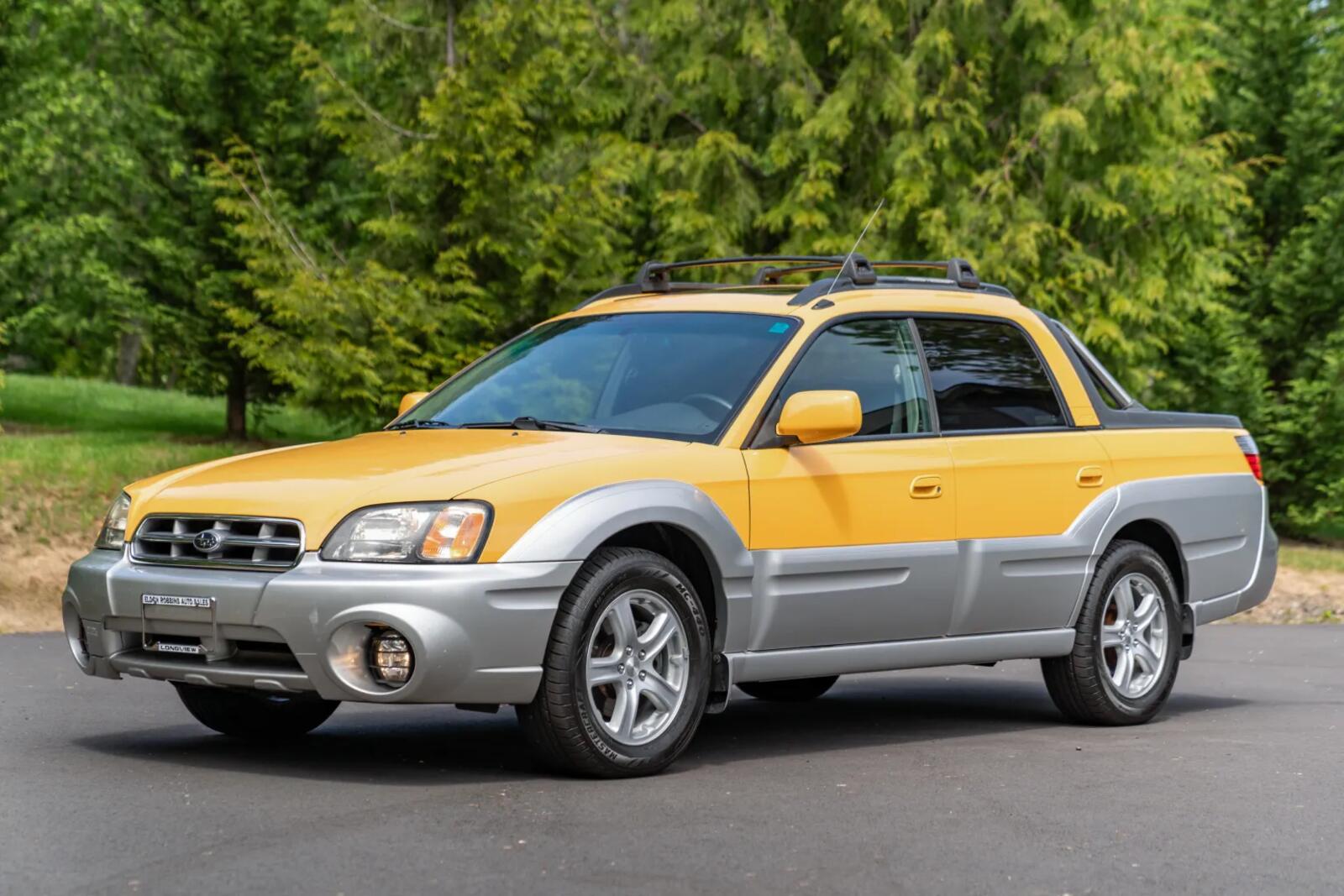 Yellow 2003 Subaru Baja parked in left front angle view