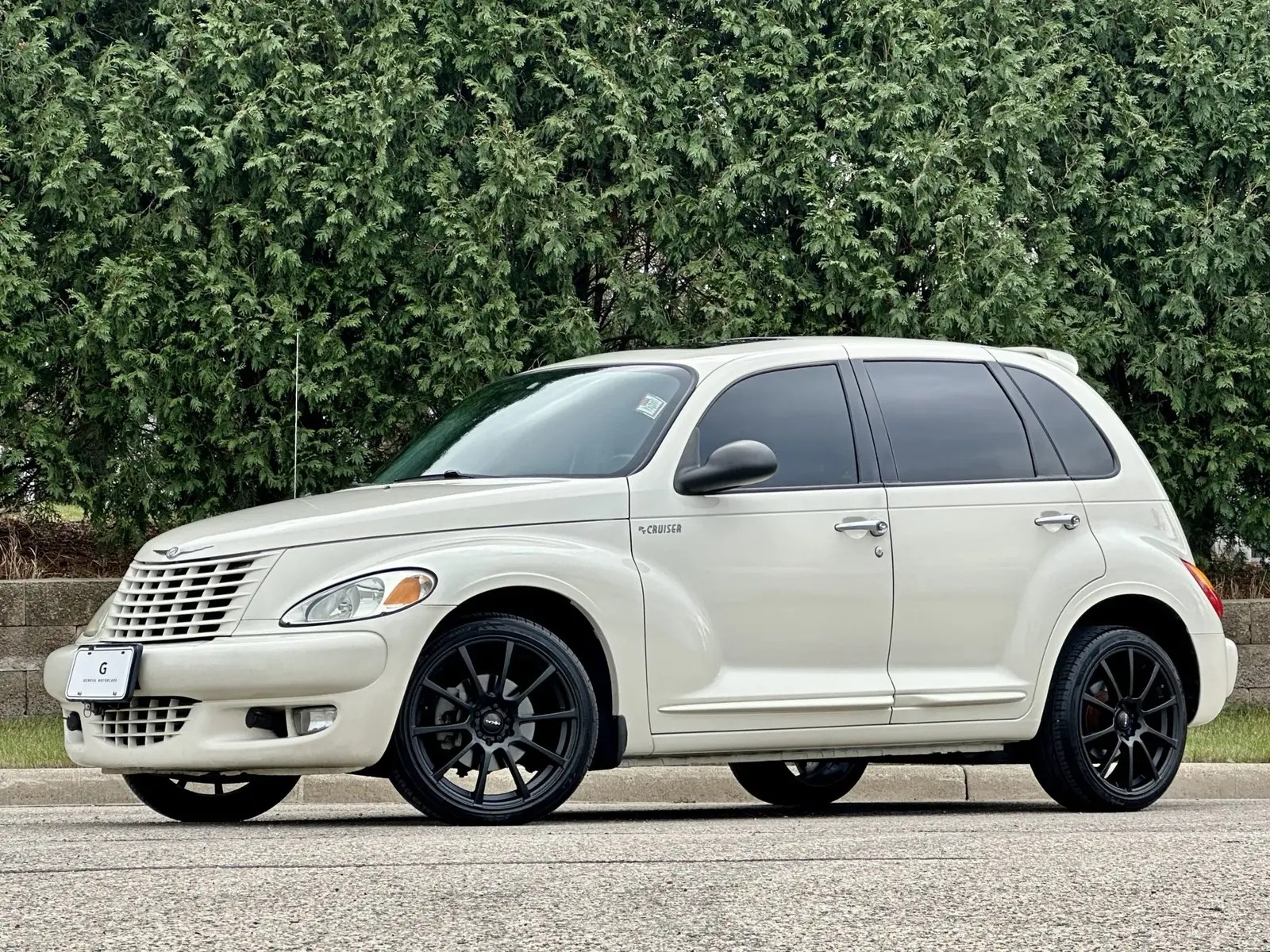 A white 2004 Chrysler PT Cruiser parked in left profile view