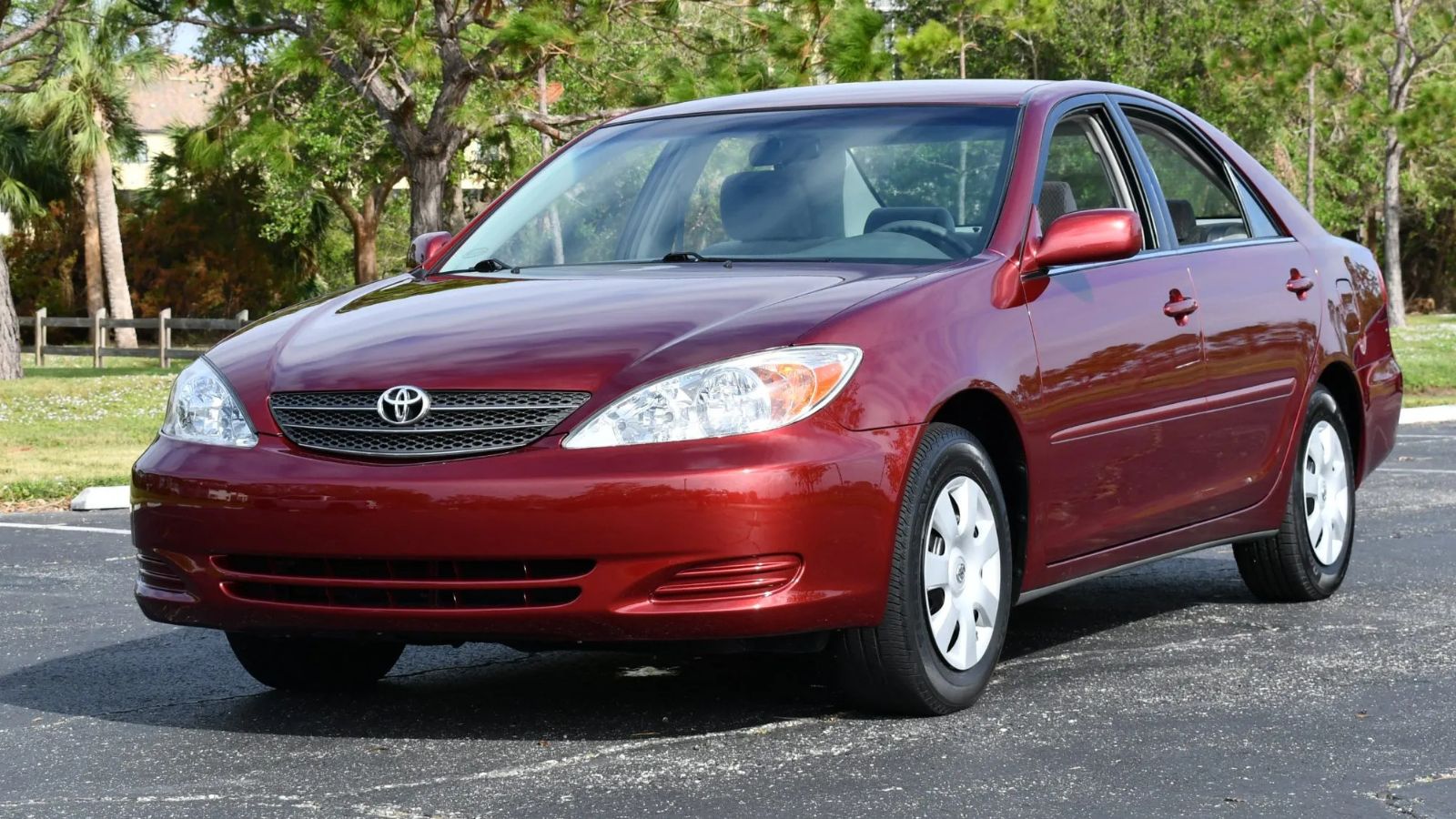 A dark red 2004 Toyota Camry parked in left front angle view