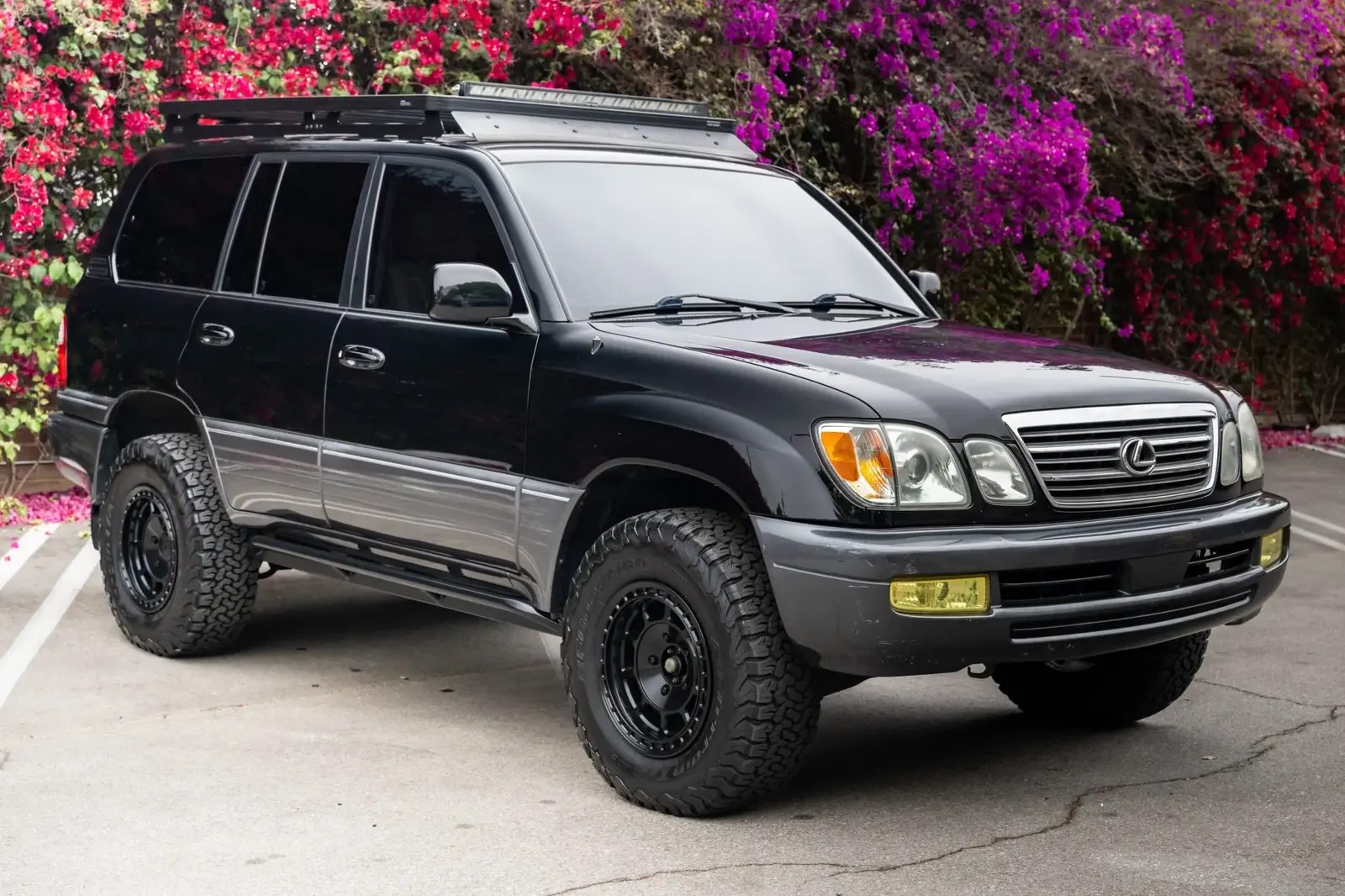 A black 2005 Lexus LX 470 parked in right front angle view