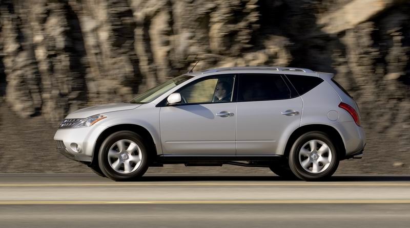 A silver 2006 Nissan Murano driving in full left profile