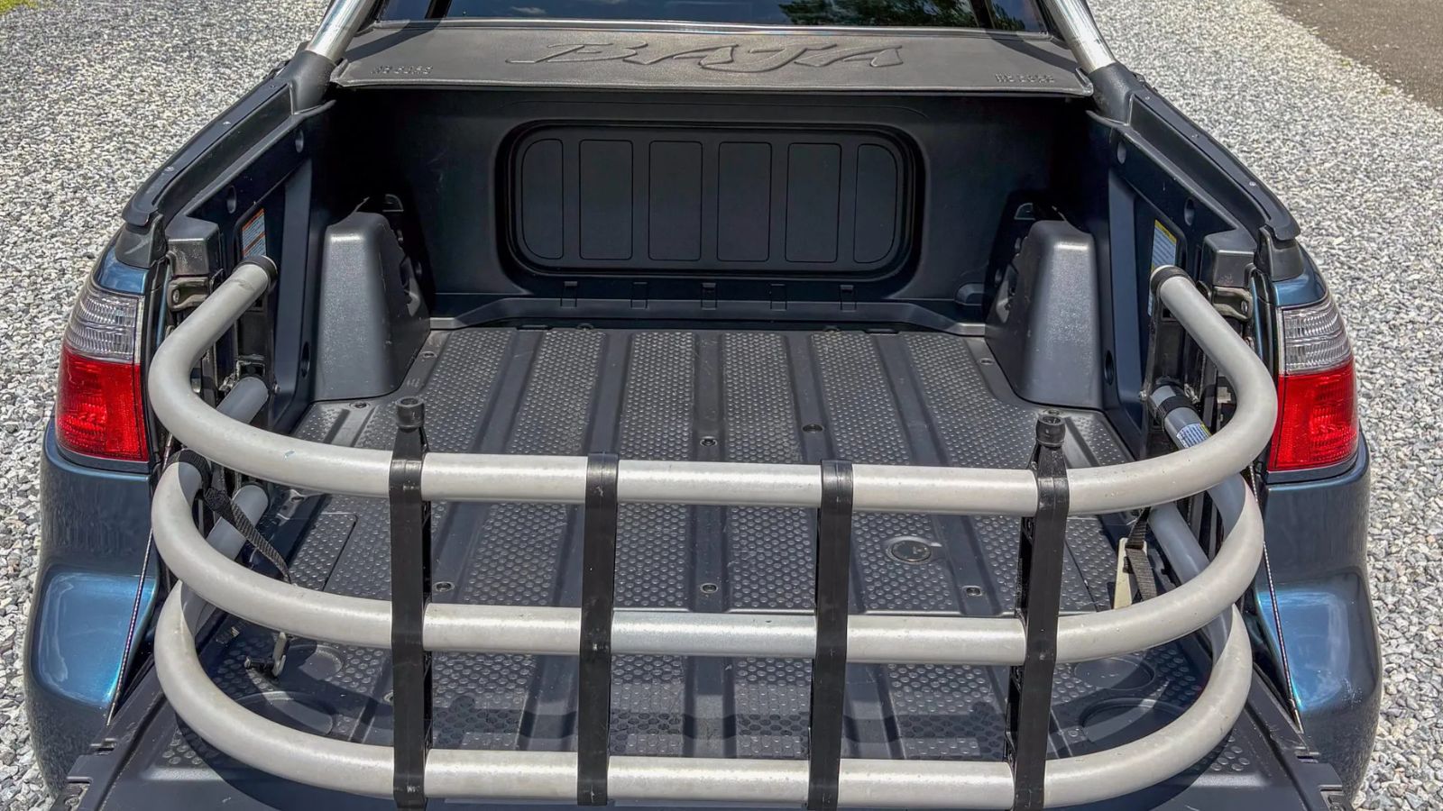 A close up of a bed extender in a 2006 Subaru Baja Turbo