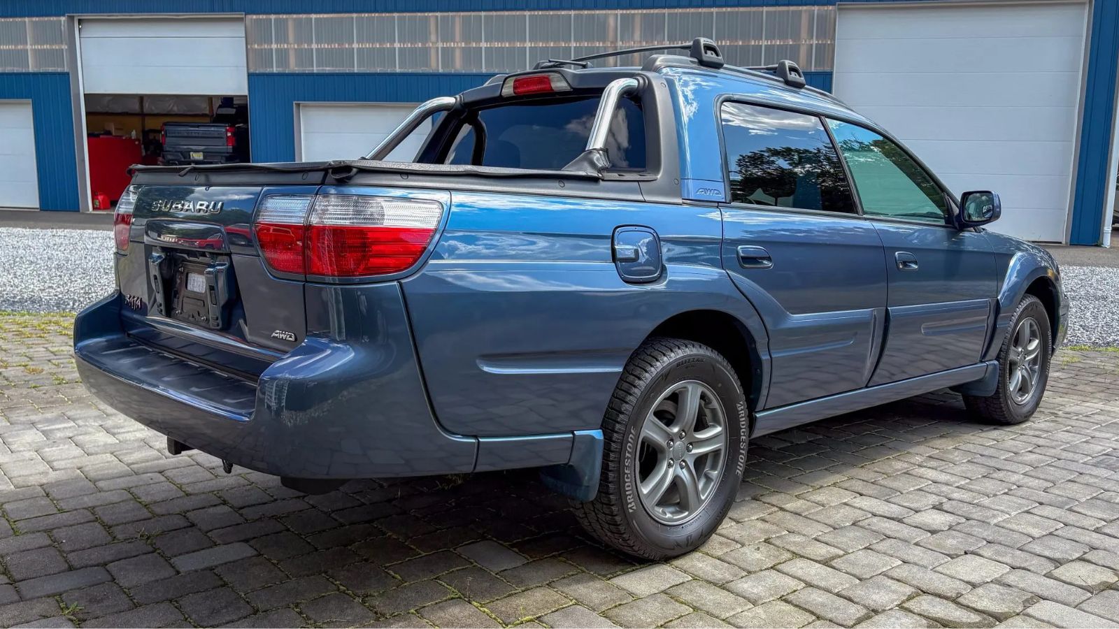 A blue 2006 Subaru Baja Turbo parked in right rear angle view