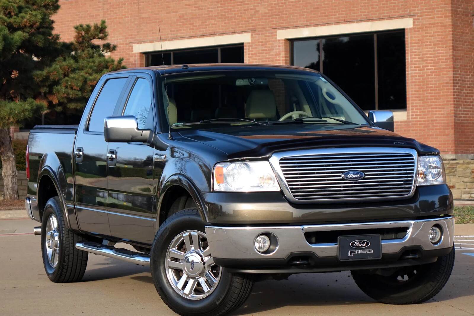 A dark colored 2008 Ford F-150 parked in right front angle view