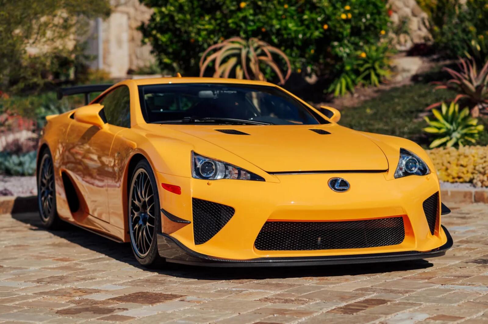 A bright yellow 2012 Lexus LFA parked in right front angle view