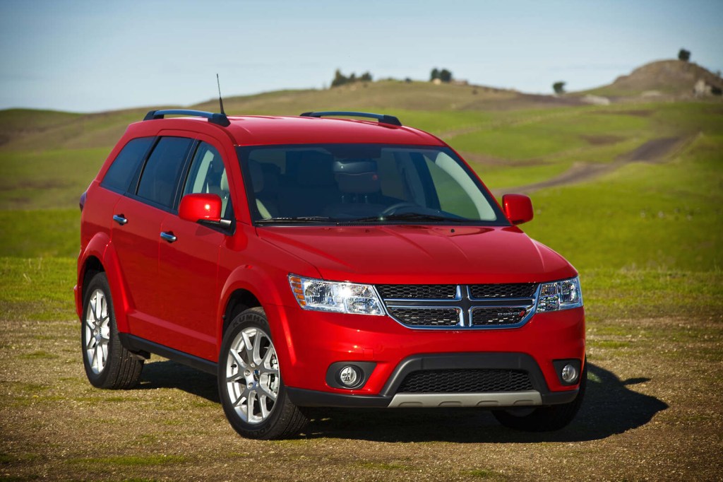 A red 2015 Dodge Journey parked in right front angle view