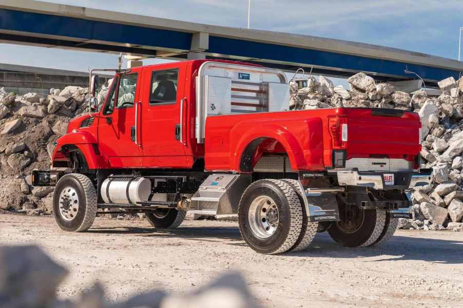 A Super Duty bed on a bright red International Harvester truck parked in a rock quarry.