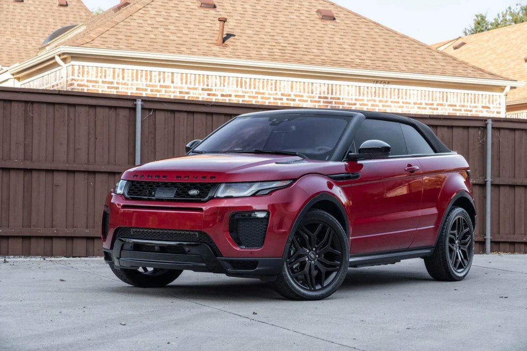 A red and black 2017 Range Rover Evoque convertible parked in left front angle view