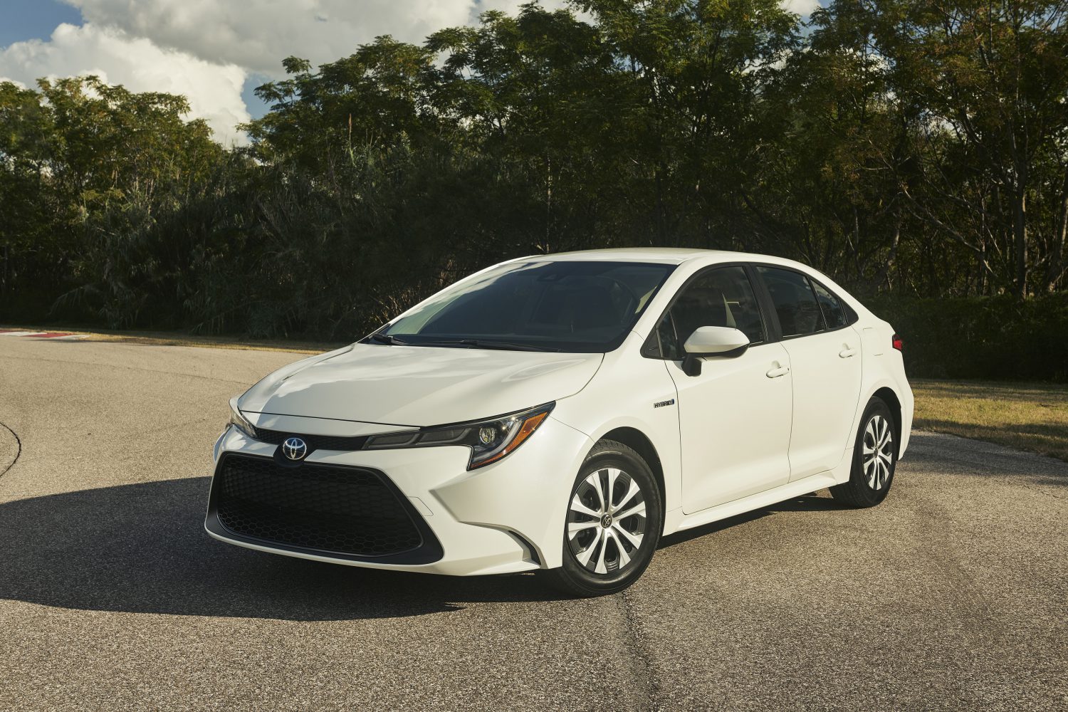 A white 2020 Toyota Corolla hybrid parked in close left front angle view
