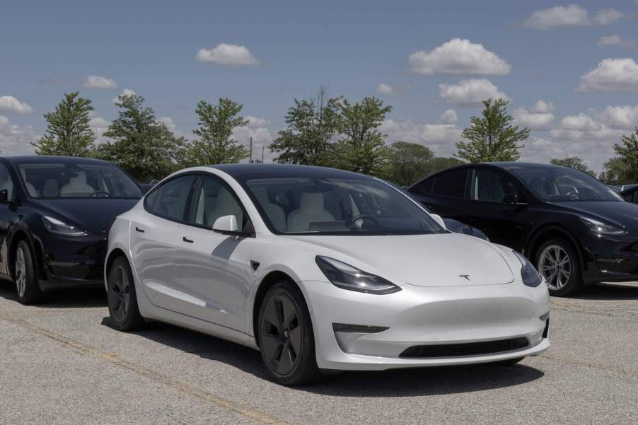 A white 2021 Tesla Model Y EV parked in right front angle view