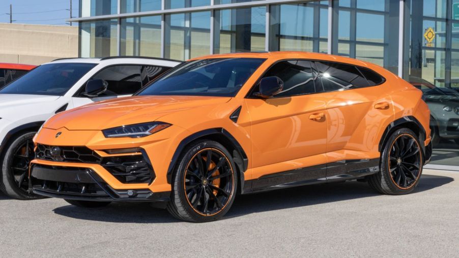 A bright orange 2022 Lamborghini Urus parked in left front angle view