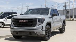 A flat gray 2024 GMC Sierra 1500 pickup truck parked in left front angle view