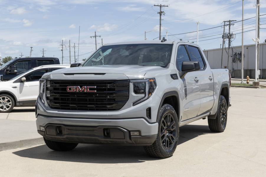 A flat gray 2024 GMC Sierra 1500 pickup truck parked in left front angle view