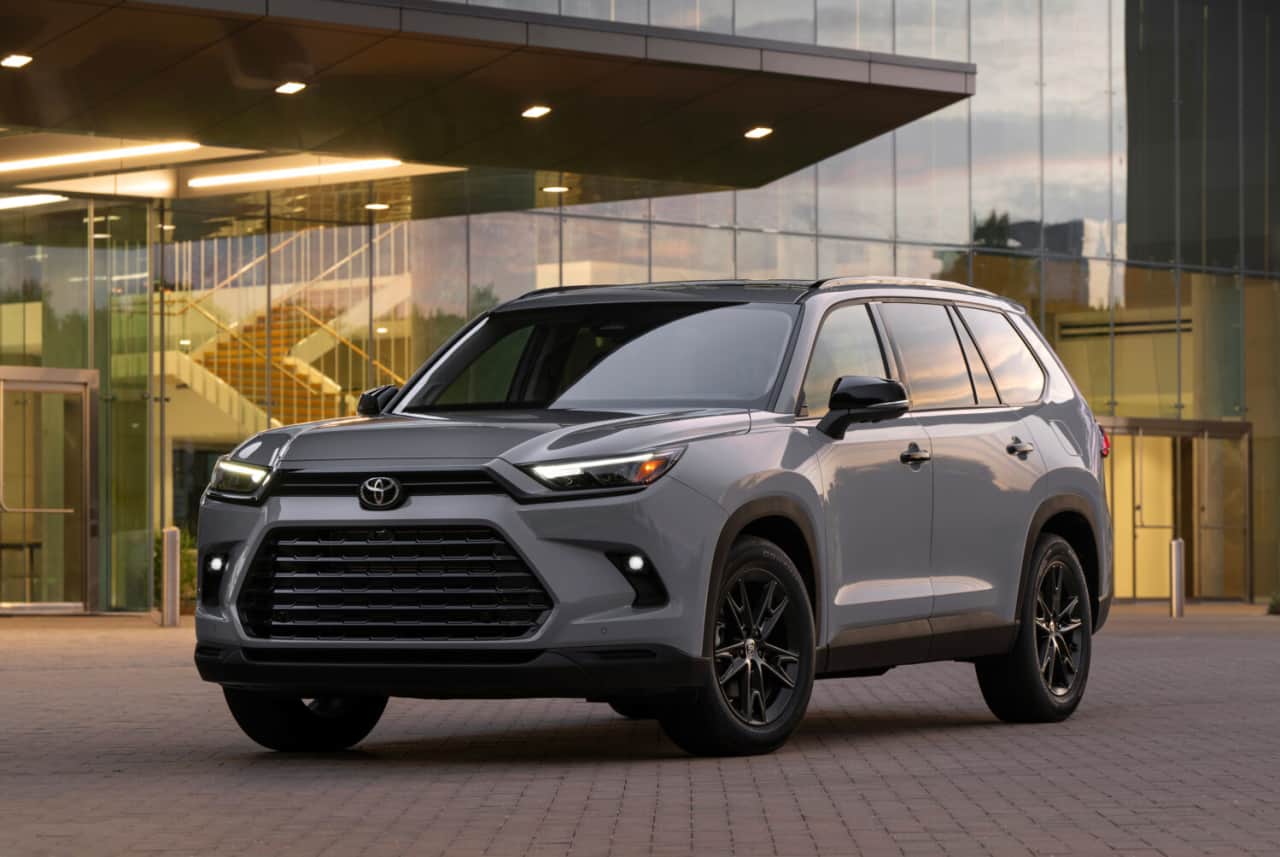 The 2025 Toyota Grand Highlander Hybrid near a building