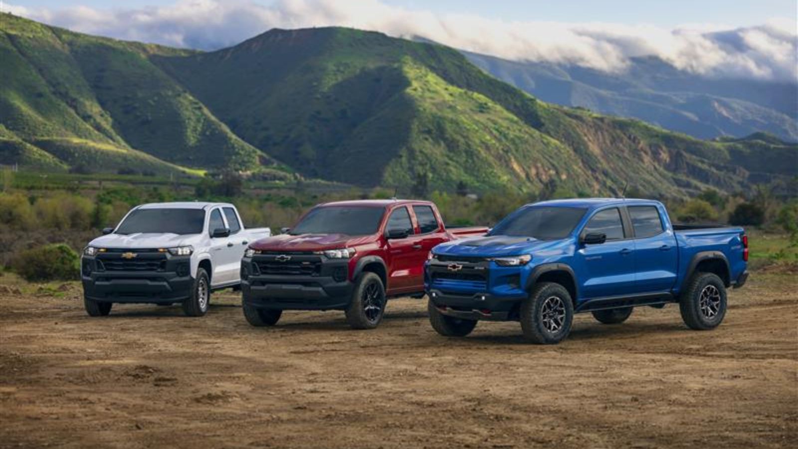 A group of three 2025 Chevrolet Colorado pickup trucks parked in left front angle view