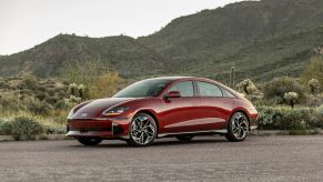 A red 2025 Hyundai Ioniq 6 parked in far left front angle view