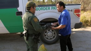 A border patrol officer near a truck