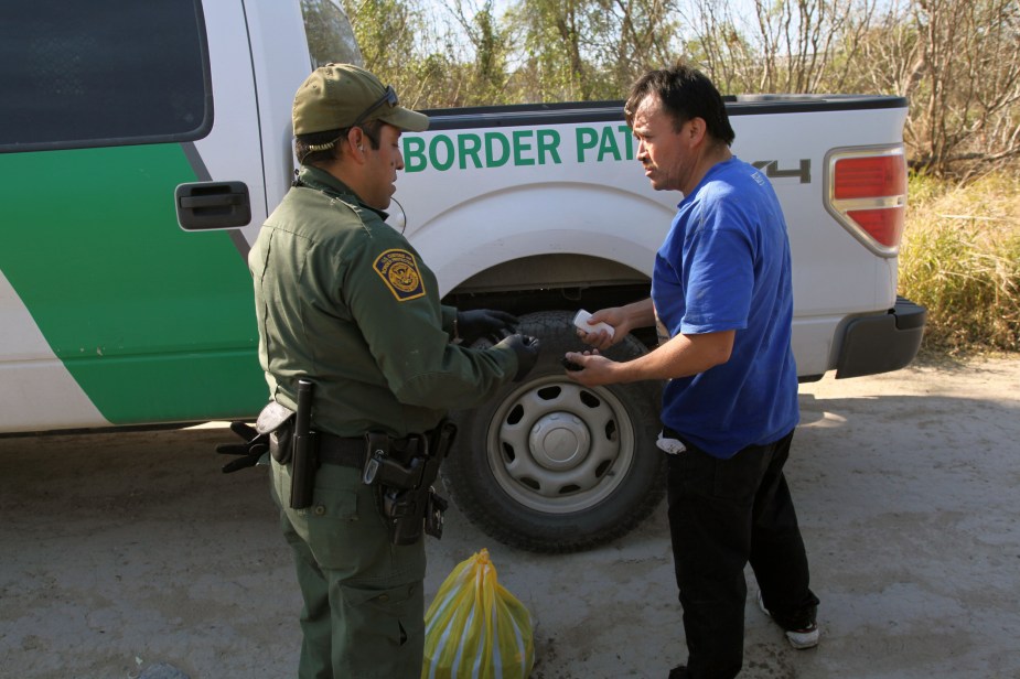 A border patrol officer near a truck