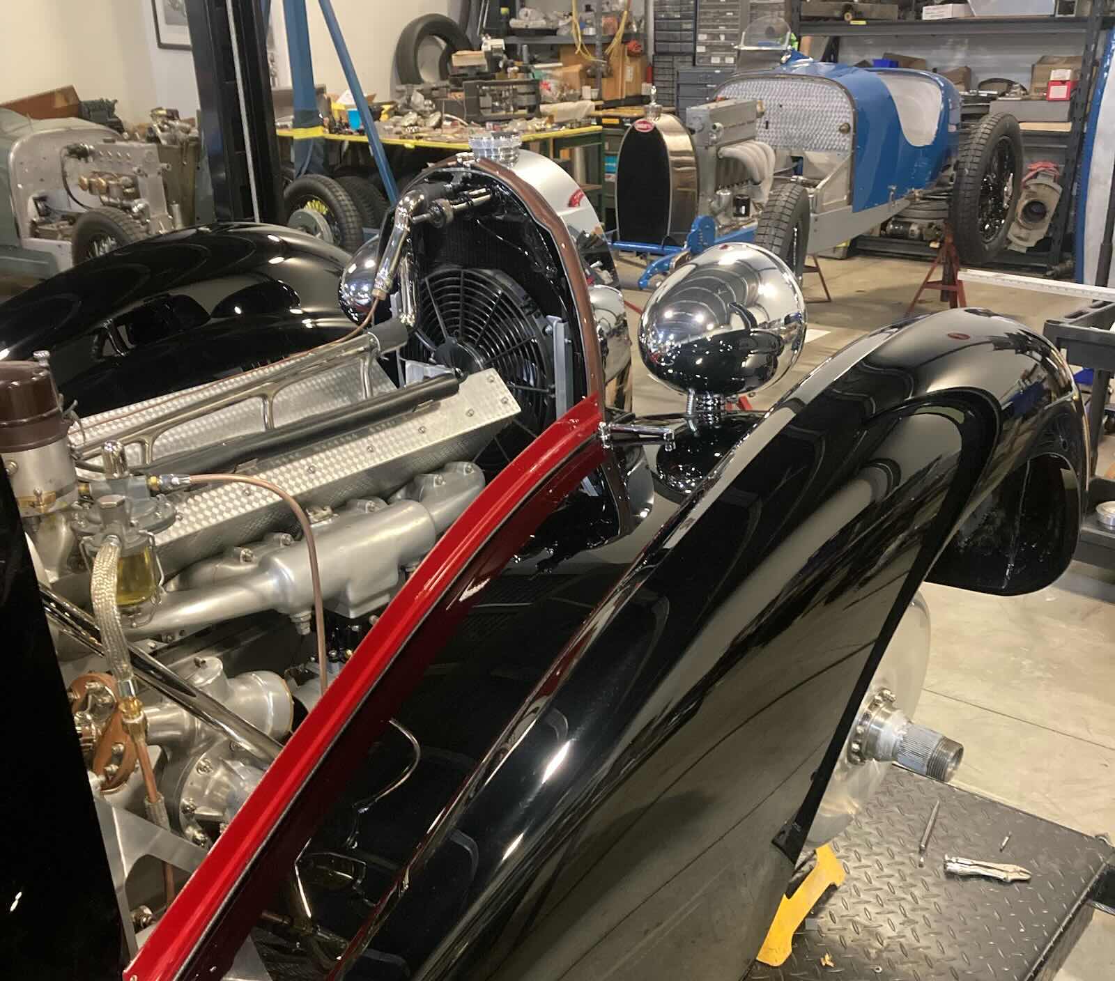Front fender of a vintage Bugatti grand touring car undergoing restoration