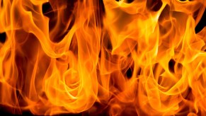 Wall of flame at a gas station while a Corvette burns after an explosion