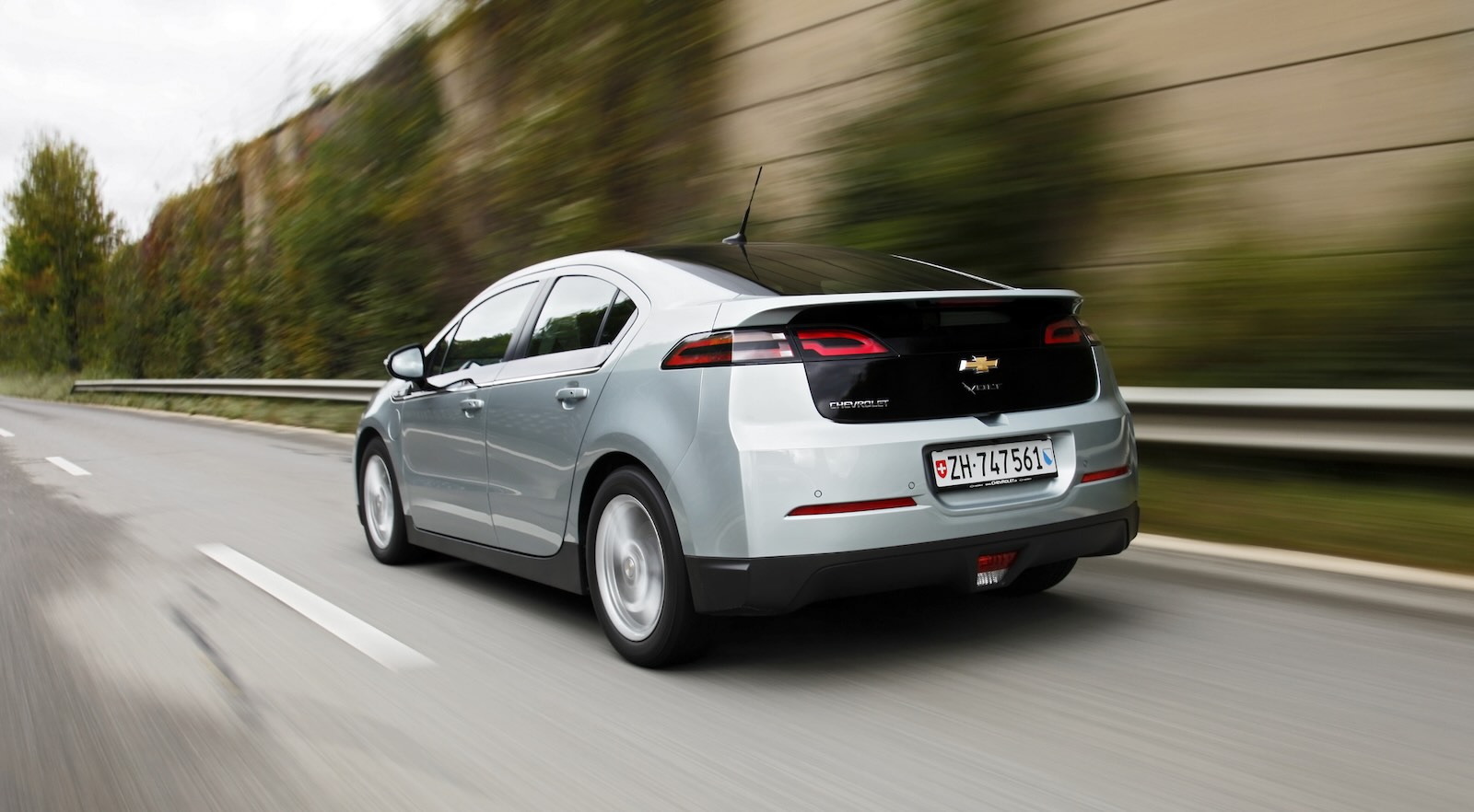 Silver Chevrolet Volt range-extended hybrid sedan driving down the highway.