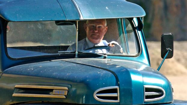 Loyal driver steering a classic Ford truck