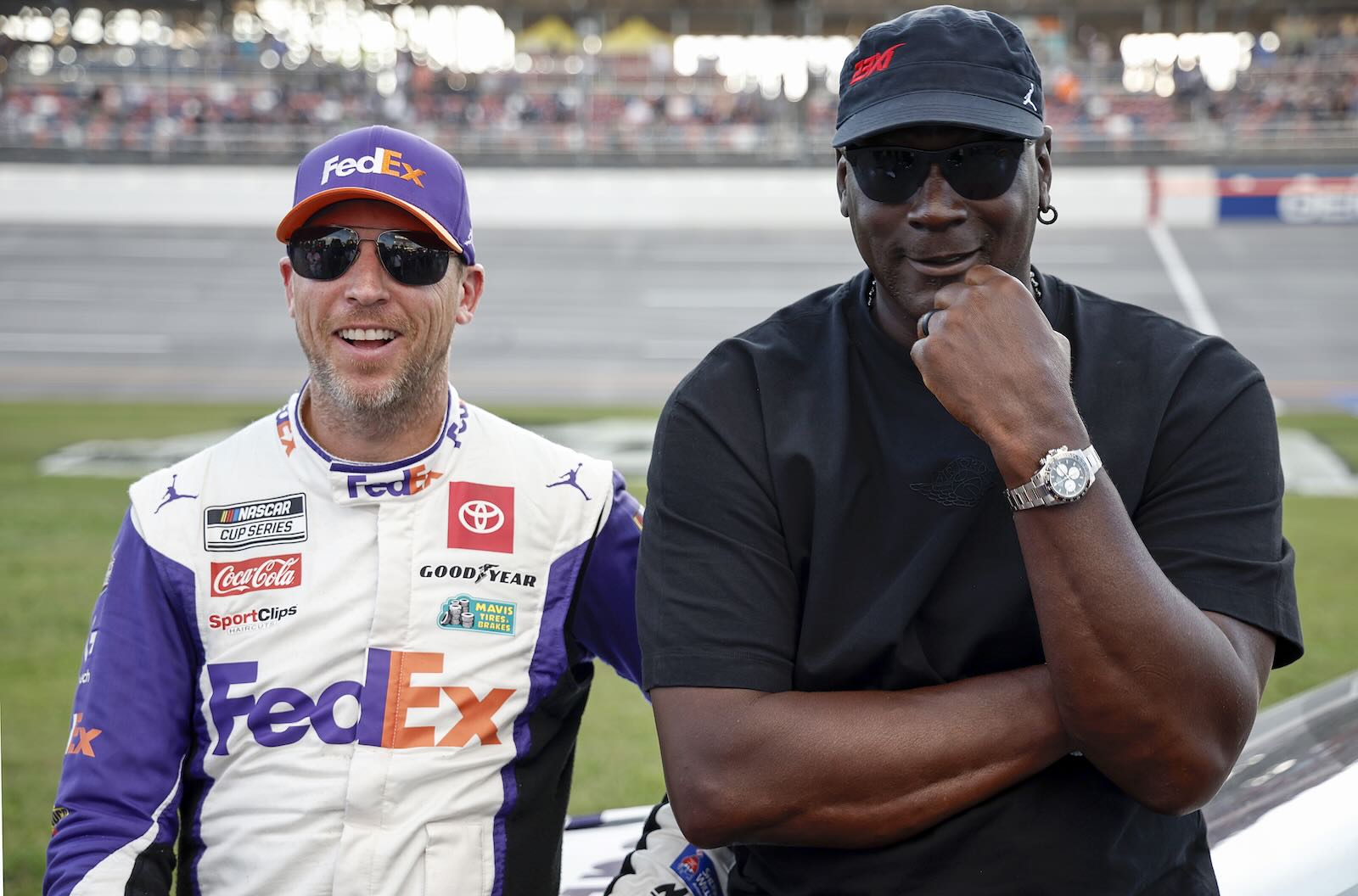 #11 driver Denny Hamlin and 23XI racing co-owner Michael Jordan pose at Talladega during NASCAR lawsuit