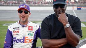 #11 driver Denny Hamlin and 23XI racing co-owner Michael Jordan pose at Talladega during NASCAR lawsuit