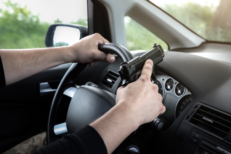 Driver holding a handgun next to his steering wheel during a Florida road rage incident.