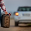 A woman holding a gas can