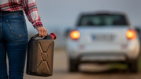 A woman holding a gas can
