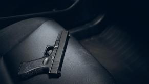 An image shows a replica gun in a car, sitting on the seat.