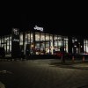 Jeep sign above a dealership lit up at night.