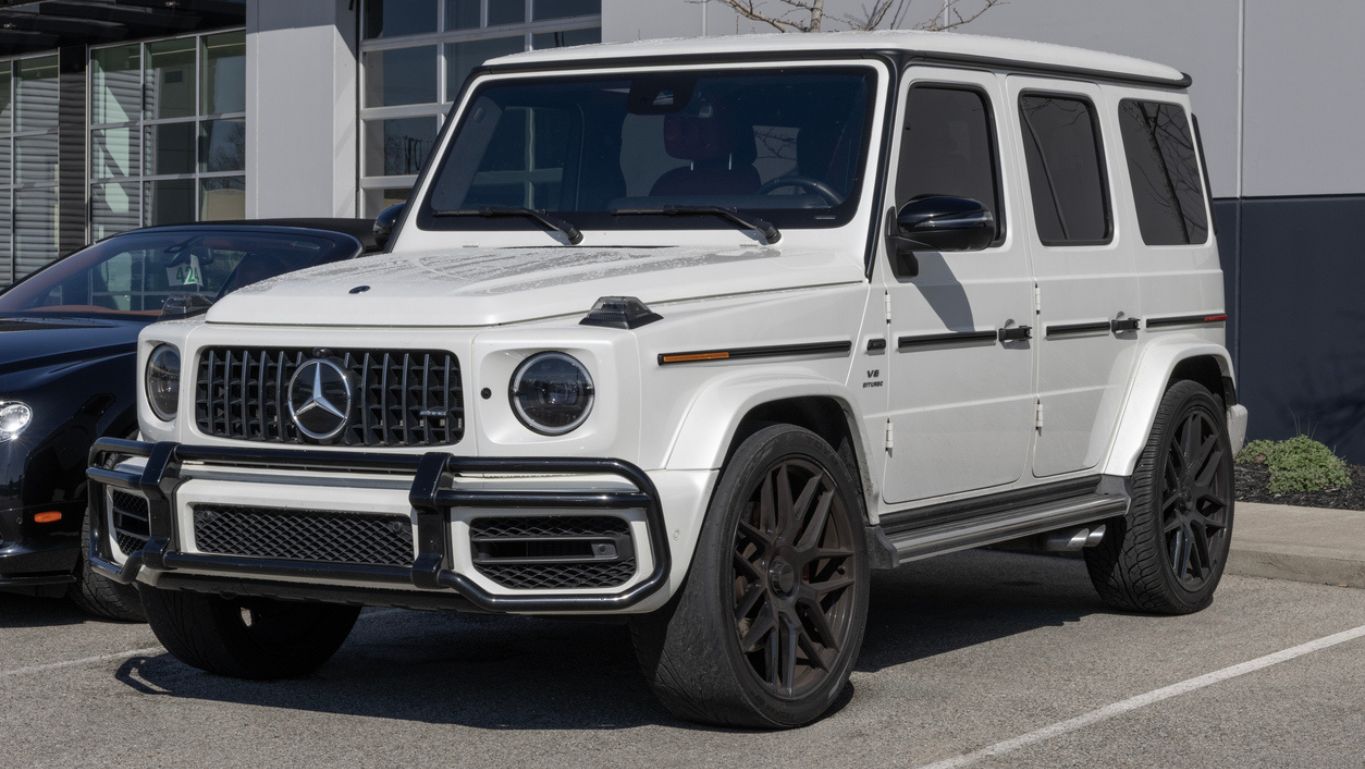 A white Mercedes-Benz G63 AMG parked in left front angle view