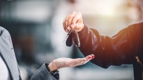 Car driver hands over keys so Fisker Ocean SUV EV can get recall work done.