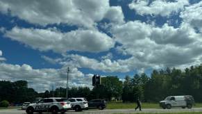 Police officers and vehicles at a stop evaluating a driver for a DUI.
