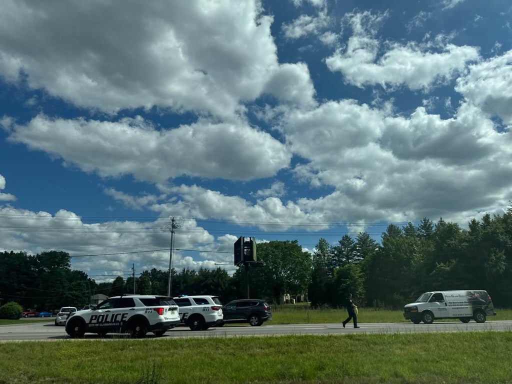 Police officers and vehicles at a stop evaluating a driver for a DUI.