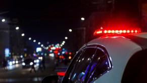The red lights atop a police cruiser after it pulls over Dodge Charger EV for noise violation