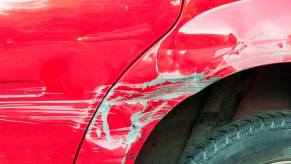 Scratches on the fender of a red audi after a crash into a police station