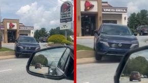 A TikToker records a Nissan SUV hitting a curb in the Taco Bell drive thru