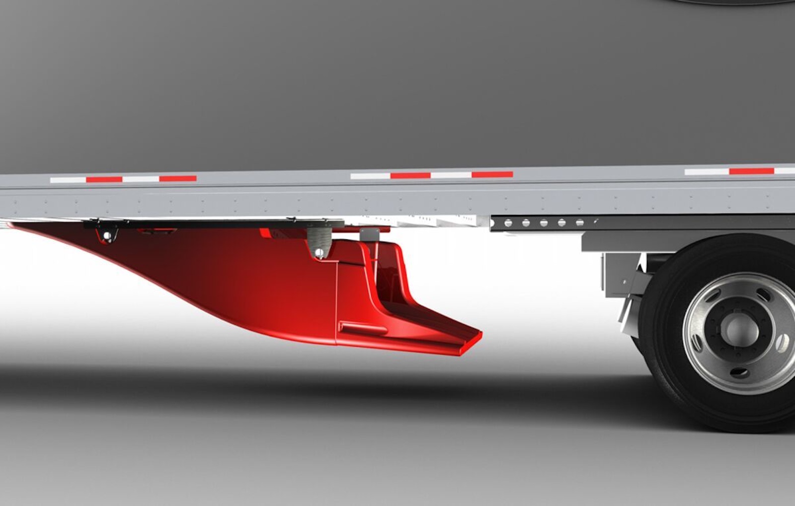 Closeup of a plastic red "under tray" beneath a semi truck to improve aerodynamics.