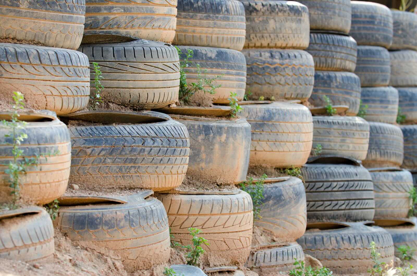 Huge stack of dirty, muddy tires forming part of the "black fortress" in Florida