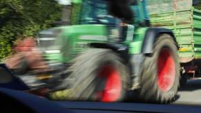 An action shot shows a car about to crash into a tractor like a recent case involving a Minnesota man.