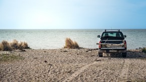 A truck in the sand on the beach
