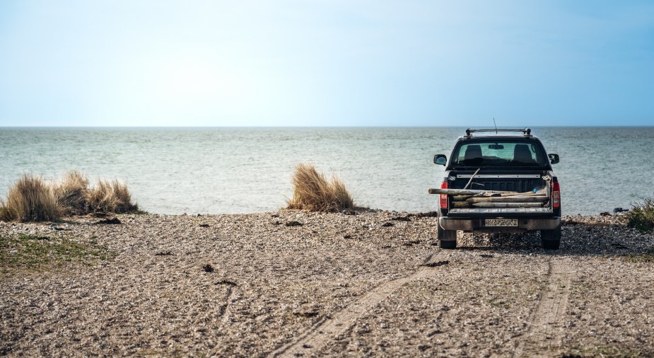 A truck in the sand on the beach