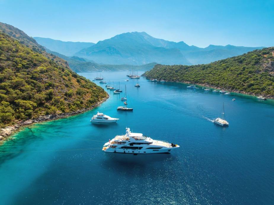 A collection of yachts in the water off the coast of Turkey.