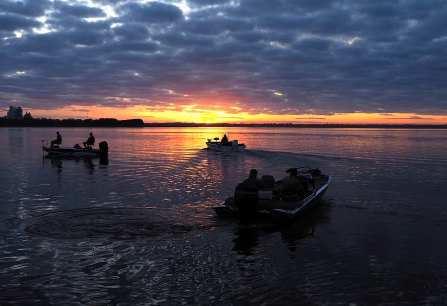 An image shows Florida boaters on the water at sunset.