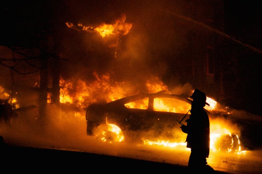 A video showed a driver behind the wheel of a car on fire.