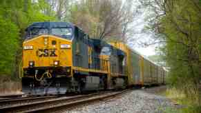 A CSX train on tracks in left front angle view